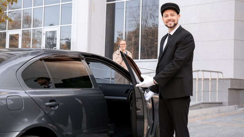 Jayride driver opening car door for client.