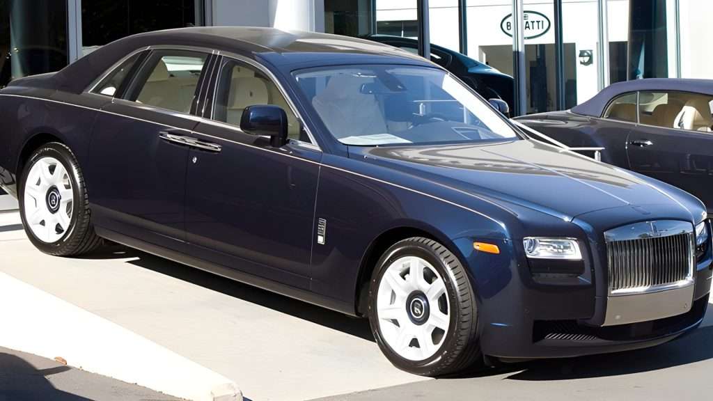 Rolls Royce Ghost luxury car driving on road.