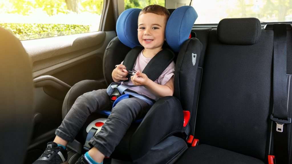 Child seat in taxi, baby enjoying ride.