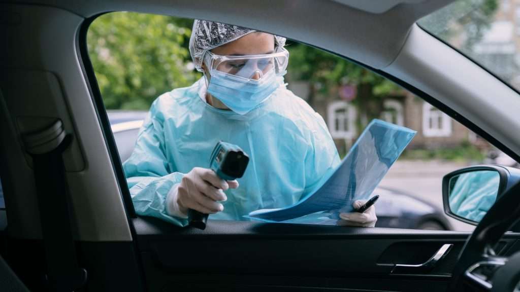 Woman checking hydrometer test on machine in car.