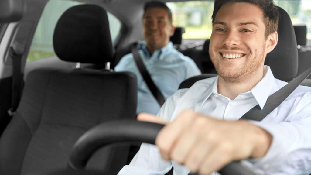 hauffeur driving a luxury car, providing a stress-free journey for their passengers.