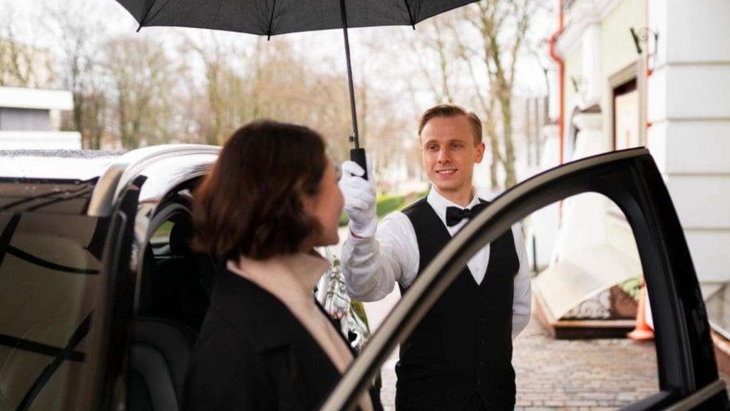 Chauffeurs assisting passenger at Imperial Hotel, Gold Coast entrance.