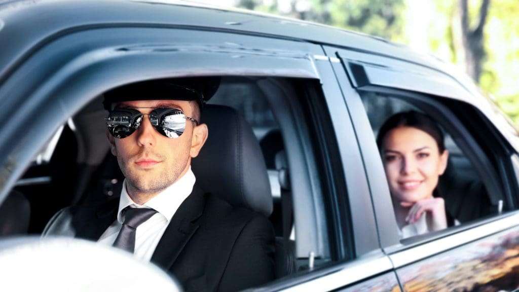 Chauffeur driving car in Gold Coast with client in back seat