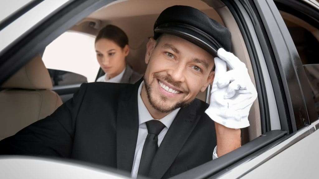 Corporate chauffeur smiling beside luxury car, professional service, friendly demeanor.