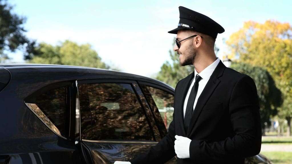 Avoiding Hidden Costs chauffeur opens luxury car door