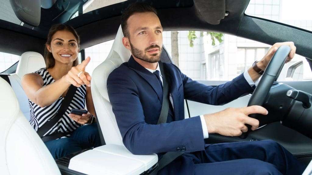 Luxury car hire chauffeur driving passenger in comfort